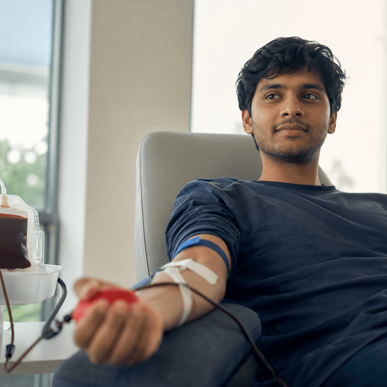 A donor giving blood at a clinic